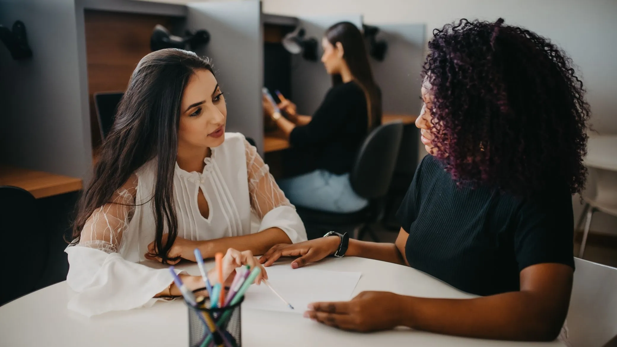 A recruiter and a candidate talking across a desk